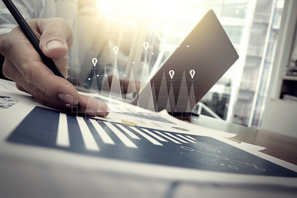 business documents on office table with smart phone and digital tablet and graph financial with social network diagram and man working in the backgro-1